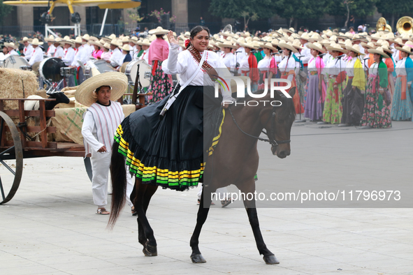 A woman dressed as a Mexican Revolutionary woman rides a horse during the parade marking the 114th anniversary of the Mexican Revolution at...