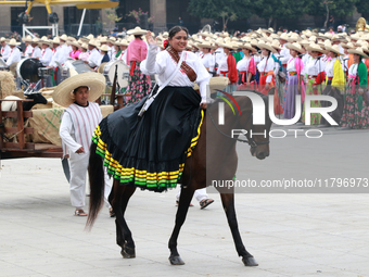 A woman dressed as a Mexican Revolutionary woman rides a horse during the parade marking the 114th anniversary of the Mexican Revolution at...