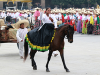 A woman dressed as a Mexican Revolutionary woman rides a horse during the parade marking the 114th anniversary of the Mexican Revolution at...