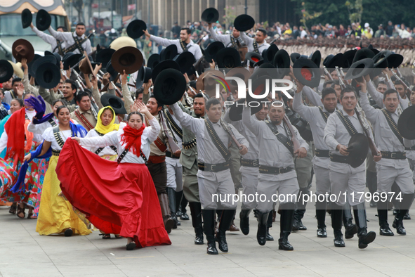 Members of the Mexican armed forces dress as they were during the Mexican Revolution and take part in a parade marking the 114th anniversary...