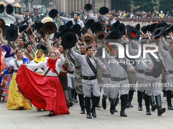 Members of the Mexican armed forces dress as they were during the Mexican Revolution and take part in a parade marking the 114th anniversary...