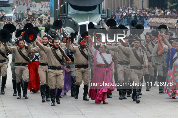 Members of the Mexican armed forces dress as they were during the Mexican Revolution and take part in a parade marking the 114th anniversary...