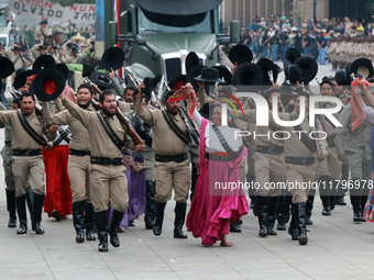 Members of the Mexican armed forces dress as they were during the Mexican Revolution and take part in a parade marking the 114th anniversary...