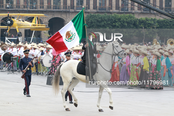 A man dressed as Francisco I. Madero rides a horse and holds a Mexican flag during the parade marking the 114th anniversary of the Mexican R...