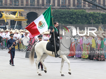 A man dressed as Francisco I. Madero rides a horse and holds a Mexican flag during the parade marking the 114th anniversary of the Mexican R...