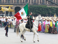 A man dressed as Francisco I. Madero rides a horse and holds a Mexican flag during the parade marking the 114th anniversary of the Mexican R...