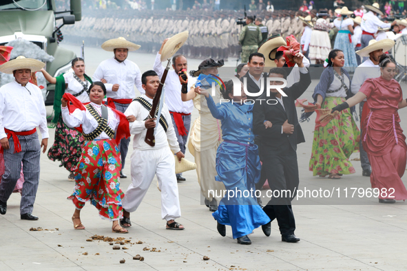 Members of the Mexican armed forces dress as they were during the Mexican Revolution and take part in a parade marking the 114th anniversary...