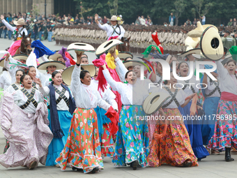 Women dressed as they were during the Mexican Revolution take part in a parade marking the 114th anniversary of the Mexican Revolution in Me...