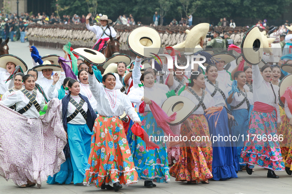 Women dressed as they were during the Mexican Revolution take part in a parade marking the 114th anniversary of the Mexican Revolution in Me...