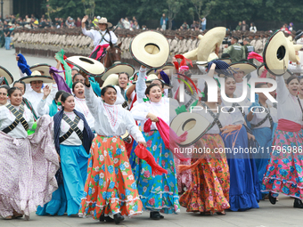 Women dressed as they were during the Mexican Revolution take part in a parade marking the 114th anniversary of the Mexican Revolution in Me...