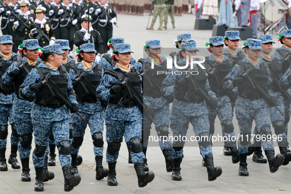 Women members of the armed forces take part in the parade marking the 114th anniversary of the Mexican Revolution at the Zocalo in Mexico Ci...