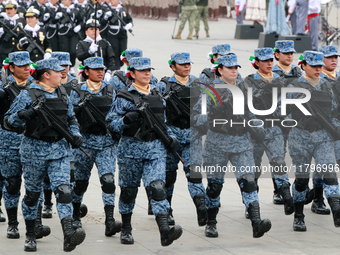 Women members of the armed forces take part in the parade marking the 114th anniversary of the Mexican Revolution at the Zocalo in Mexico Ci...