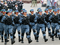 Women members of the armed forces take part in the parade marking the 114th anniversary of the Mexican Revolution at the Zocalo in Mexico Ci...