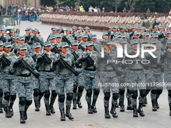 Women belonging to the National Guard participate in the parade on the occasion of the 114th anniversary of the Mexican Revolution at the Zo...