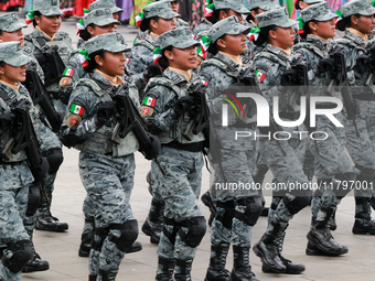 Women belonging to the National Guard participate in the parade on the occasion of the 114th anniversary of the Mexican Revolution at the Zo...