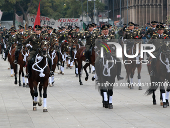 Members of the Mexican armed forces, mounted on horses, take part in the parade marking the 114th anniversary of the Mexican Revolution at t...