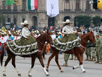 Charro women ride horses during the parade for the 114th anniversary of the Mexican Revolution at the Zocalo capital, in Mexico City, Mexico...