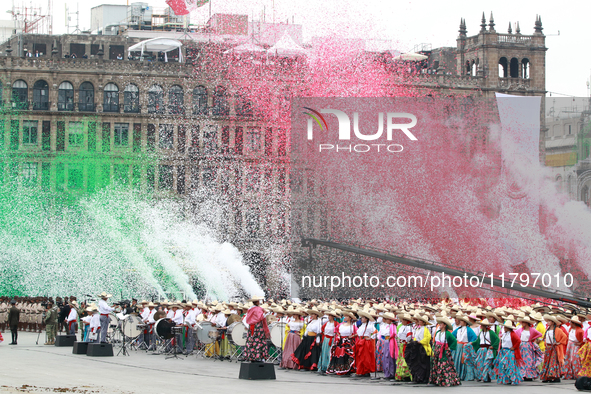 Confetti in the colors of the Mexican flag (green, white, and red) is thrown at the end of the parade on the occasion of the 114th anniversa...