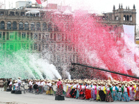 Confetti in the colors of the Mexican flag (green, white, and red) is thrown at the end of the parade on the occasion of the 114th anniversa...