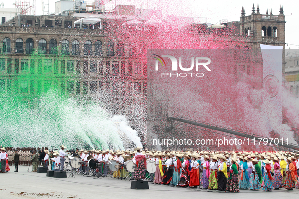 Confetti in the colors of the Mexican flag (green, white, and red) is thrown at the end of the parade on the occasion of the 114th anniversa...