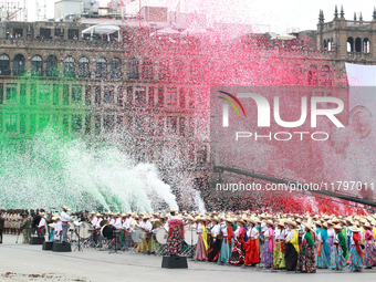 Confetti in the colors of the Mexican flag (green, white, and red) is thrown at the end of the parade on the occasion of the 114th anniversa...