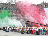 Confetti in the colors of the Mexican flag (green, white, and red) is thrown at the end of the parade on the occasion of the 114th anniversa...