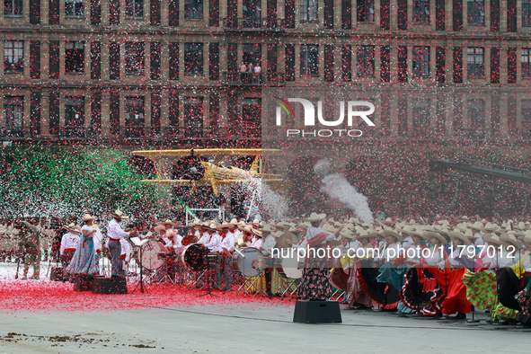 Confetti in the colors of the Mexican flag (green, white, and red) is thrown at the end of the parade on the occasion of the 114th anniversa...