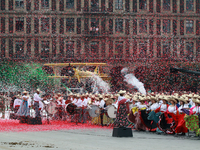 Confetti in the colors of the Mexican flag (green, white, and red) is thrown at the end of the parade on the occasion of the 114th anniversa...