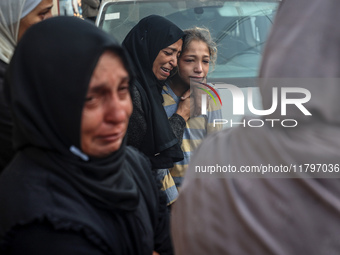 Mourners react during the funeral of Palestinians killed in an Israeli strike at Al-Aqsa Martyrs Hospital in Deir Al-Balah, in the central G...