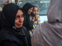 Mourners react during the funeral of Palestinians killed in an Israeli strike at Al-Aqsa Martyrs Hospital in Deir Al-Balah, in the central G...