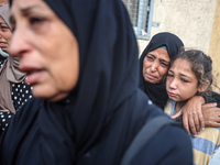 Mourners react during the funeral of Palestinians killed in an Israeli strike at Al-Aqsa Martyrs Hospital in Deir Al-Balah, in the central G...