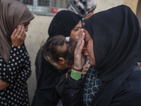 Mourners react during the funeral of Palestinians killed in an Israeli strike at Al-Aqsa Martyrs Hospital in Deir Al-Balah, in the central G...