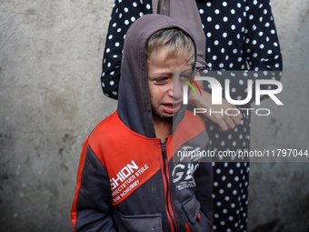 Mourners react during the funeral of Palestinians killed in an Israeli strike at Al-Aqsa Martyrs Hospital in Deir Al-Balah, in the central G...