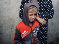 Mourners react during the funeral of Palestinians killed in an Israeli strike at Al-Aqsa Martyrs Hospital in Deir Al-Balah, in the central G...