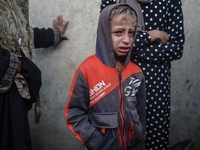 Mourners react during the funeral of Palestinians killed in an Israeli strike at Al-Aqsa Martyrs Hospital in Deir Al-Balah, in the central G...