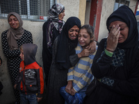 Mourners react during the funeral of Palestinians killed in an Israeli strike at Al-Aqsa Martyrs Hospital in Deir Al-Balah, in the central G...