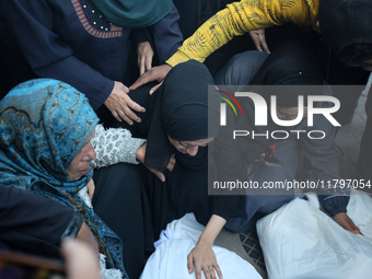 Mourners react during the funeral of Palestinians killed in an Israeli strike at Al-Aqsa Martyrs Hospital in Deir Al-Balah, in the central G...