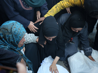 Mourners react during the funeral of Palestinians killed in an Israeli strike at Al-Aqsa Martyrs Hospital in Deir Al-Balah, in the central G...