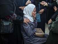 Mourners react during the funeral of Palestinians killed in an Israeli strike at Al-Aqsa Martyrs Hospital in Deir Al-Balah, in the central G...