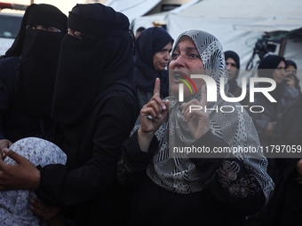 Mourners react during the funeral of Palestinians killed in an Israeli strike at Al-Aqsa Martyrs Hospital in Deir Al-Balah, in the central G...