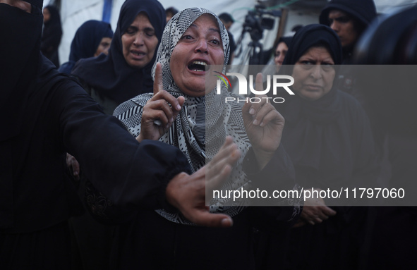 Mourners react during the funeral of Palestinians killed in an Israeli strike at Al-Aqsa Martyrs Hospital in Deir Al-Balah, in the central G...