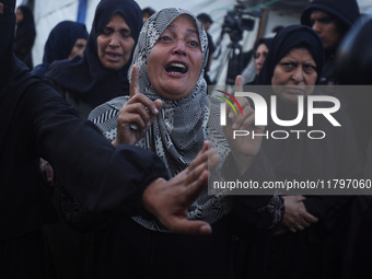 Mourners react during the funeral of Palestinians killed in an Israeli strike at Al-Aqsa Martyrs Hospital in Deir Al-Balah, in the central G...