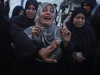 Mourners react during the funeral of Palestinians killed in an Israeli strike at Al-Aqsa Martyrs Hospital in Deir Al-Balah, in the central G...