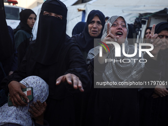 Mourners react during the funeral of Palestinians killed in an Israeli strike at Al-Aqsa Martyrs Hospital in Deir Al-Balah, in the central G...