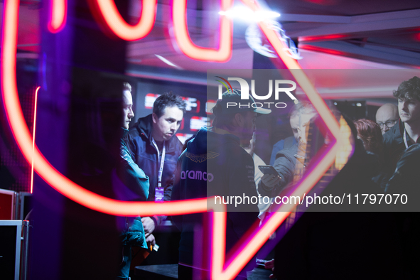 Fernando Alonso speaks to the press as seen through a neon sign ahead of the Formula 1 Heineken Silver Las Vegas Grand Prix in Las Vegas, Ne...