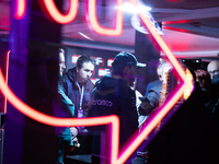 Fernando Alonso speaks to the press as seen through a neon sign ahead of the Formula 1 Heineken Silver Las Vegas Grand Prix in Las Vegas, Ne...