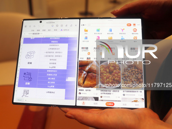 Huawei's first triple foldable screen phone, the Mate XT, is displayed at Huawei's global flagship store in Shanghai, China, on October 15,...