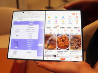 Huawei's first triple foldable screen phone, the Mate XT, is displayed at Huawei's global flagship store in Shanghai, China, on October 15,...