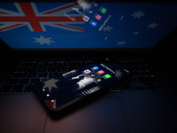 Social network logos display on a smartphone screen and the Australian flag appears on a computer screen in this photo illustration in Athen...