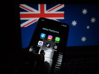 Social network logos display on a smartphone screen and the Australian flag appears on a computer screen in this photo illustration in Athen...